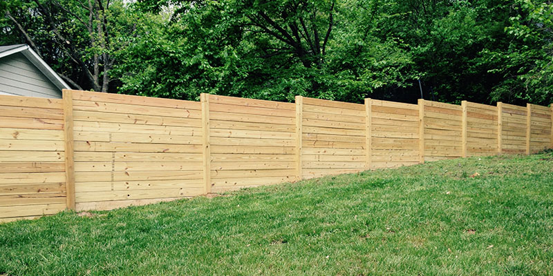 How a Wood Fence is Installed on a Sloping Lot